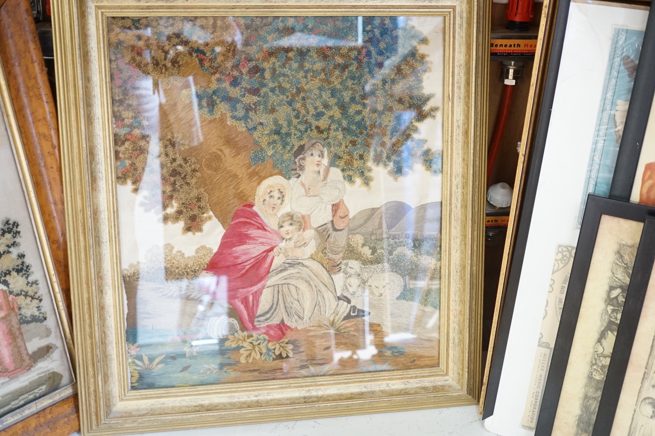 A framed Regency embroidery, two later figurative embroideries and a pair of embroidered slipper fronts, Regency embroidery 37cm wide, 41cm high